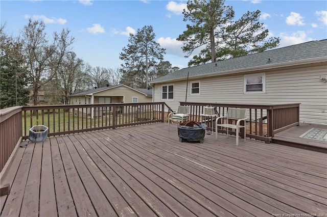 wooden terrace featuring an outdoor fire pit