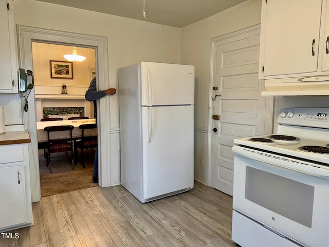 4715 Jacksontown Rd, Manson, NC 27553 - kitchen featuring light wood-style flooring, white cabinetry, white appliances, and under cabinet range hood