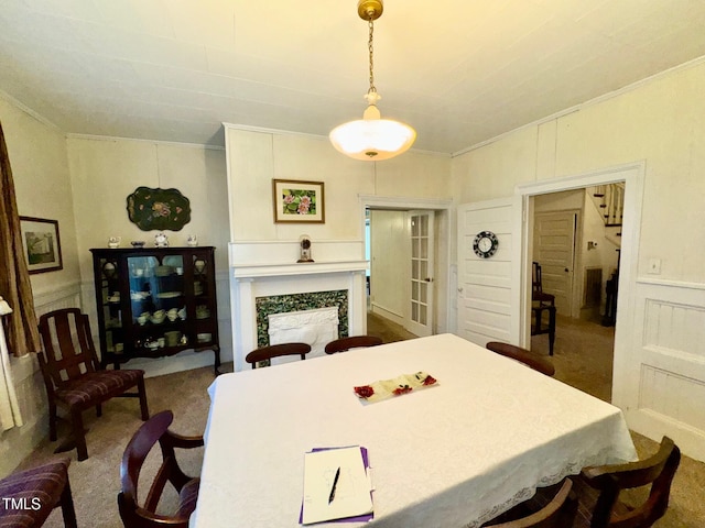 4715 Jacksontown Rd, Manson, NC 27553 - dining area with ornamental molding, a fireplace, carpet floors, wainscoting, and a decorative wall