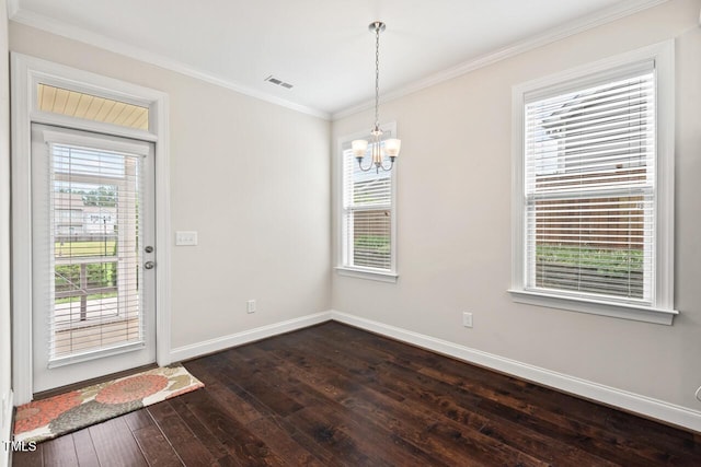 unfurnished dining area featuring dark wood-type flooring, baseboards, plenty of natural light, and crown molding