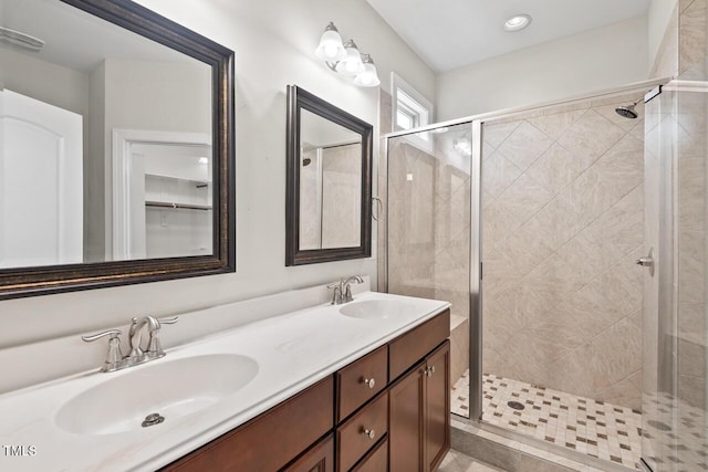 bathroom featuring a stall shower and double vanity