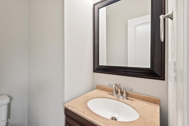 bathroom with toilet and vanity