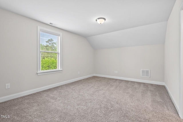 bonus room featuring carpet flooring, lofted ceiling, and baseboards