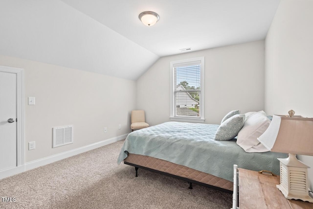 carpeted bedroom featuring vaulted ceiling and baseboards