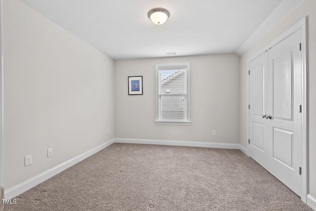 unfurnished bedroom featuring carpet flooring and baseboards