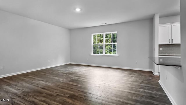1005 Ocean Ct, Carthage, NC 28327 - unfurnished living room with dark wood-style flooring and baseboards