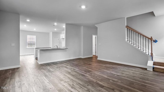 1005 Ocean Ct, Carthage, NC 28327 - unfurnished living room with dark wood finished floors, stairway, and recessed lighting