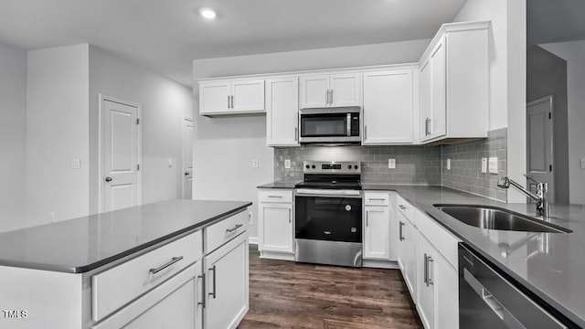 1005 Ocean Ct, Carthage, NC 28327 - kitchen featuring stainless steel appliances, white cabinetry, dark wood-style floors, dark countertops, and recessed lighting