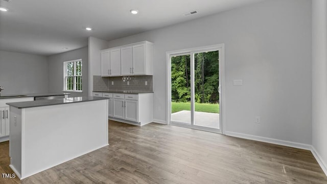 1005 Ocean Ct, Carthage, NC 28327 - kitchen featuring white cabinetry, decorative backsplash, wood finished floors, recessed lighting, and a center island