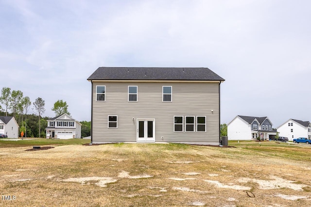 back of property with a residential view, central air condition unit, and french doors