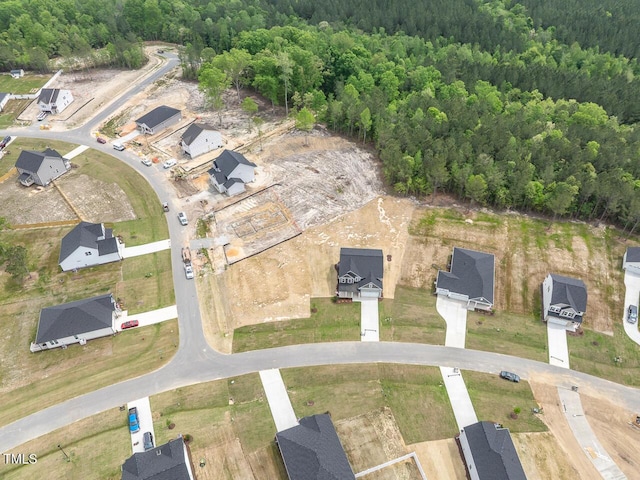 birds eye view of property with a wooded view