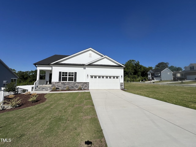 228 Pecan Valley Way, Four Oaks, NC 27524 - view of front of home with an attached garage, stone siding, driveway, and a front lawn