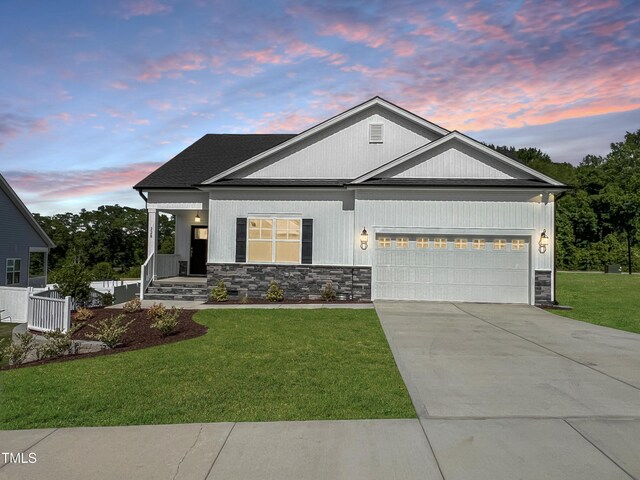228 Pecan Valley Way, Four Oaks, NC 27524 - ranch-style house featuring stone siding, a garage, a front lawn, and concrete driveway