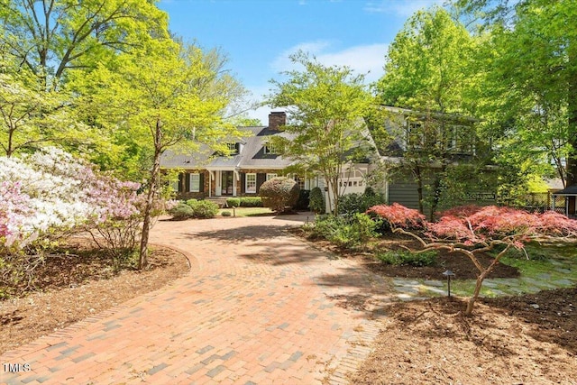 cape cod-style house with a chimney