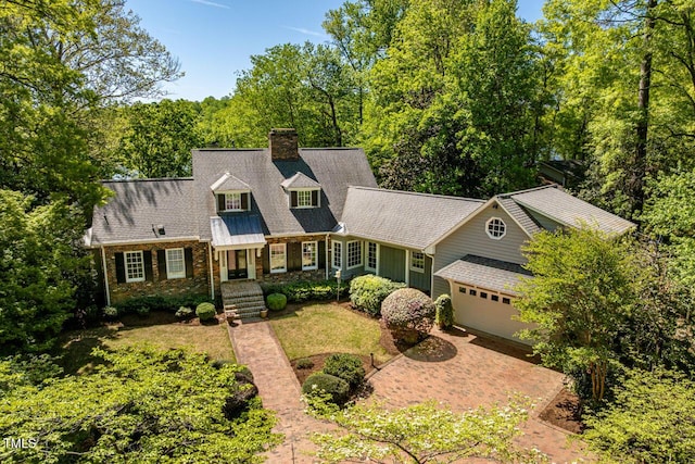 shingle-style home with a garage and a chimney