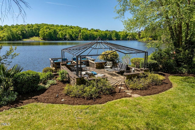 dock featuring a water view, a lawn, a gazebo, and a forest view