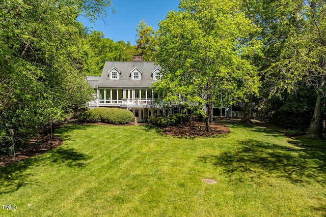view of green lawn with a deck