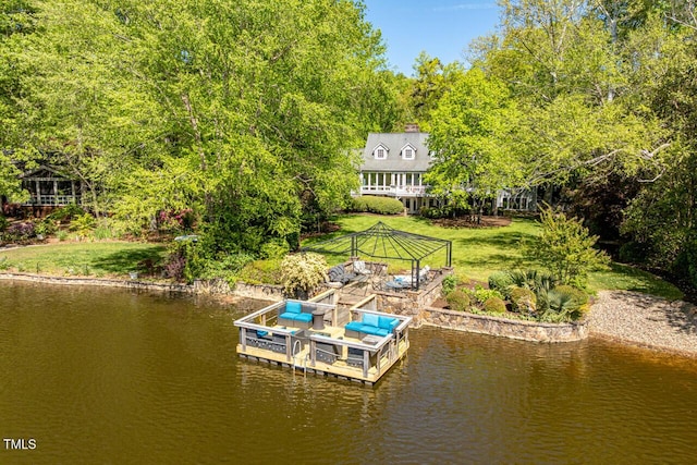 dock area with a water view, a yard, and a gazebo
