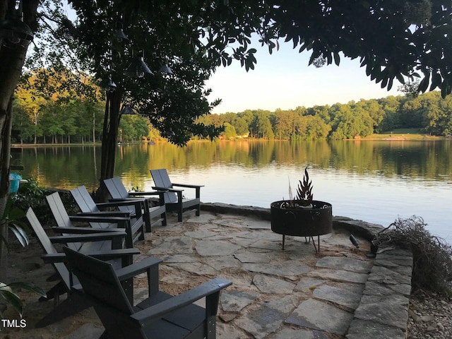 view of patio / terrace with a water view and a forest view