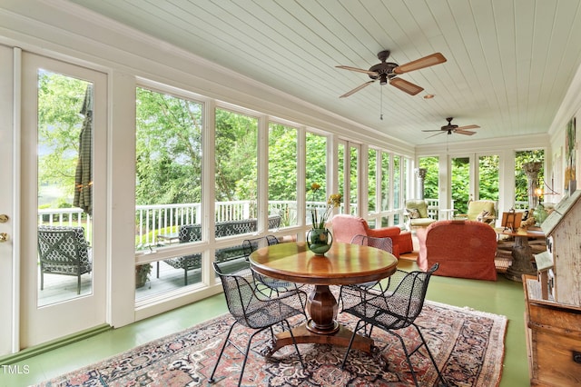 sunroom featuring healthy amount of natural light, wood ceiling, and crown molding