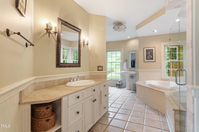 full bathroom featuring a sink, a wainscoted wall, a bath, recessed lighting, and a shower stall
