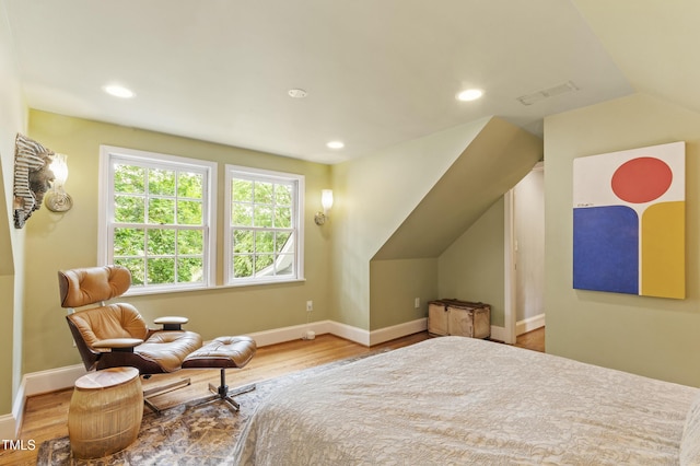 bedroom with lofted ceiling, wood finished floors, baseboards, and recessed lighting