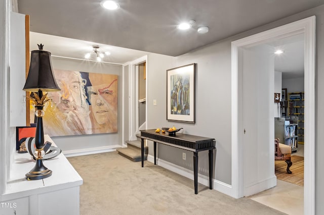 hallway featuring light carpet, stairs, baseboards, and recessed lighting