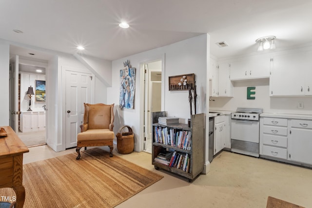 kitchen featuring electric stove, light countertops, white cabinets, recessed lighting, and finished concrete floors