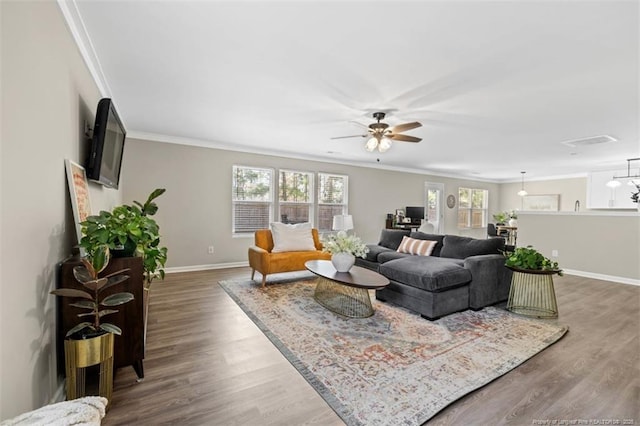 living room featuring crown molding, ceiling fan, baseboards, and dark wood finished floors