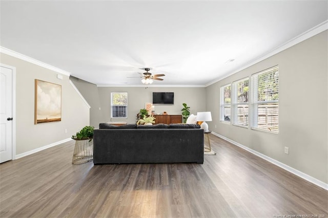 living room with dark wood finished floors, ceiling fan, and a healthy amount of sunlight