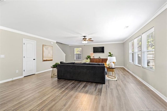 living room with ornamental molding, baseboards, a ceiling fan, and wood finished floors