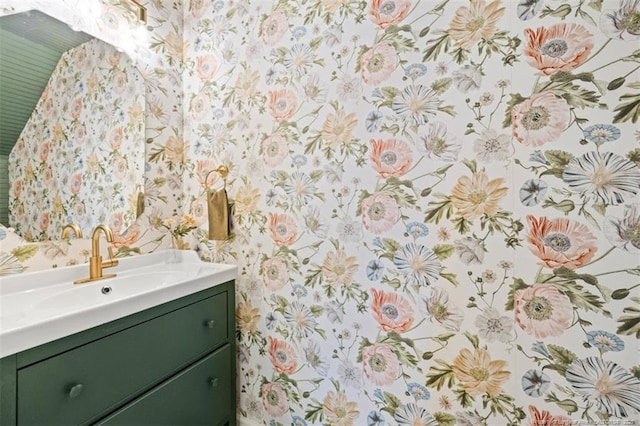 bathroom featuring wallpapered walls and vanity