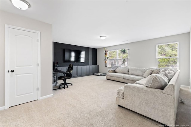 living area with baseboards and carpet floors
