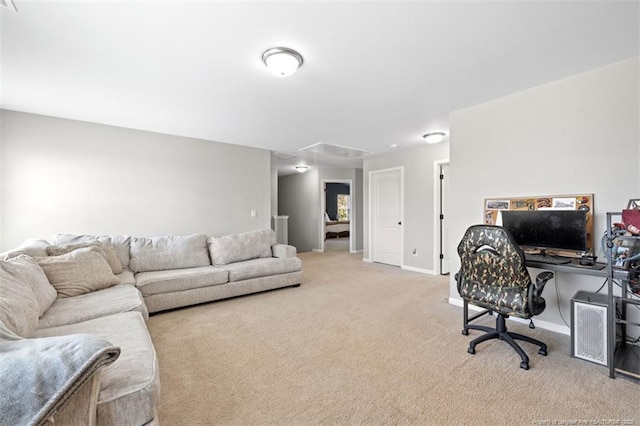 carpeted office space with baseboards and attic access
