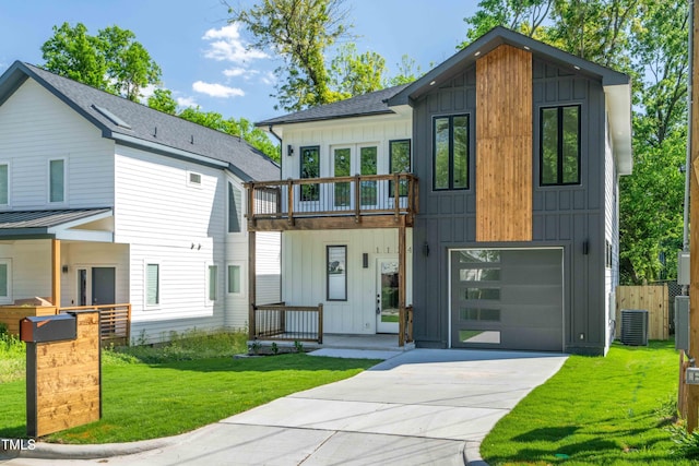 contemporary home featuring board and batten siding, a garage, cooling unit, a front lawn, and concrete driveway