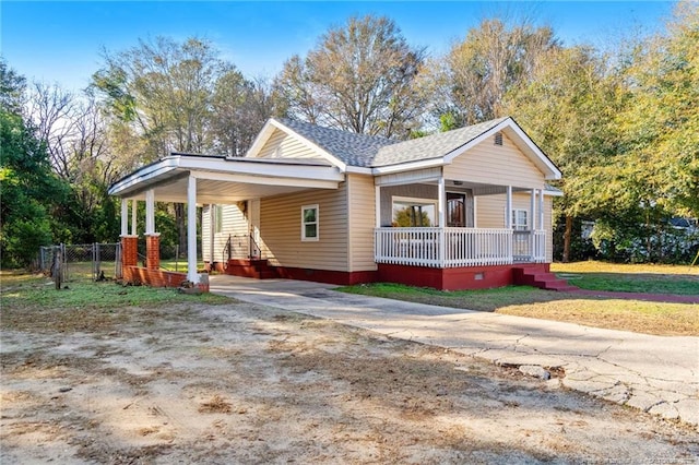 view of front of house featuring a gate, fence, covered porch, a carport, and concrete driveway