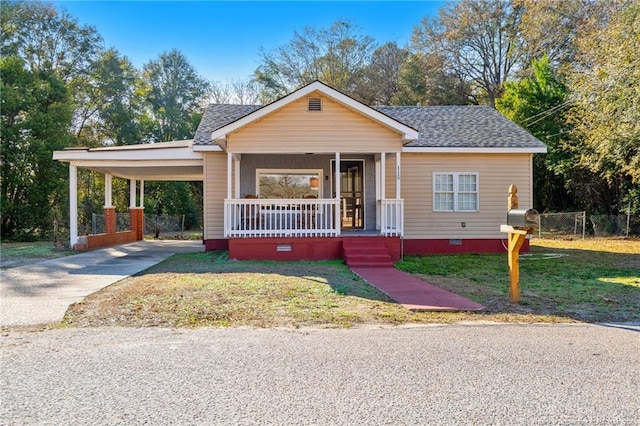 view of front of home with a carport, covered porch, driveway, and crawl space