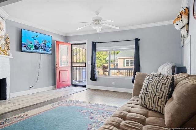 living area with wood finished floors, a brick fireplace, ceiling fan, and ornamental molding