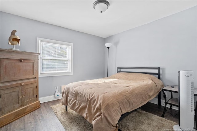 bedroom featuring baseboards and wood finished floors