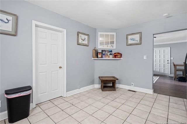 interior space with light tile patterned floors, visible vents, and baseboards