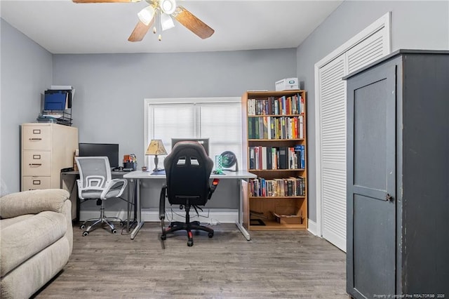 office space with wood finished floors, baseboards, and ceiling fan