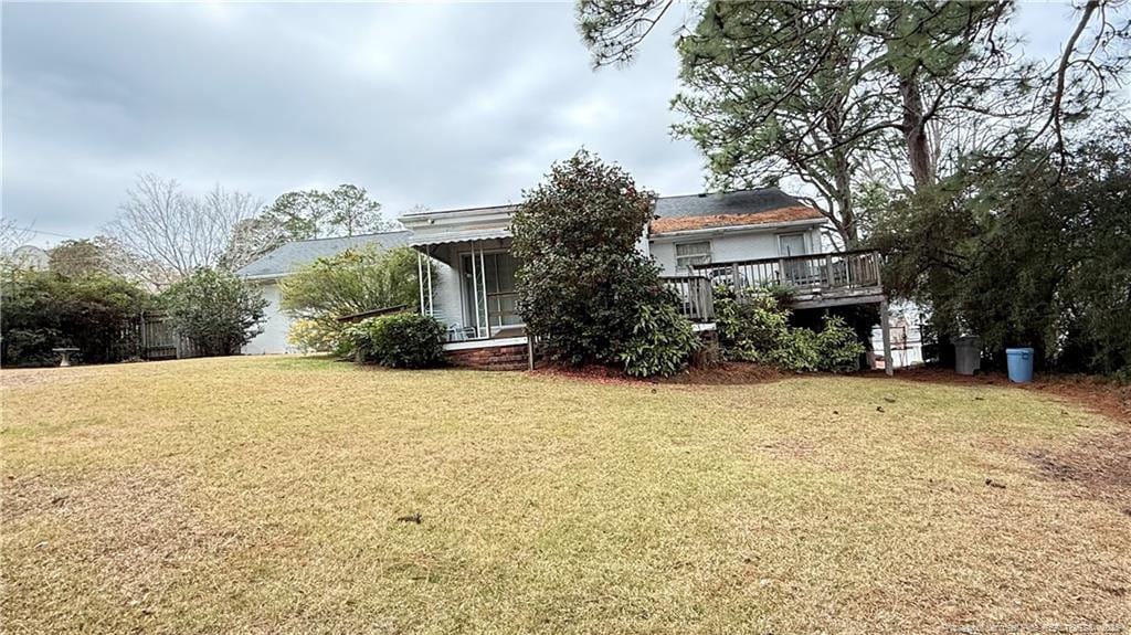 exterior space featuring a lawn and a wooden deck