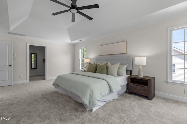 carpeted bedroom featuring baseboards, visible vents, and multiple windows