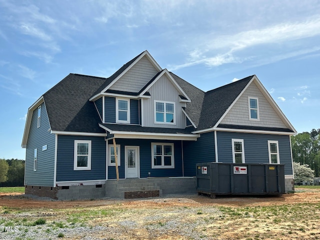 view of front of property with covered porch, crawl space, and roof with shingles