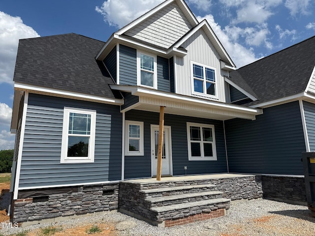 craftsman-style home with covered porch and board and batten siding