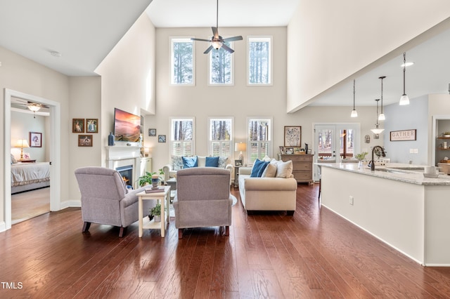 50 Lockamy Ln, Youngsville, NC 27596 - living room with a glass covered fireplace, baseboards, dark wood-style floors, and a ceiling fan