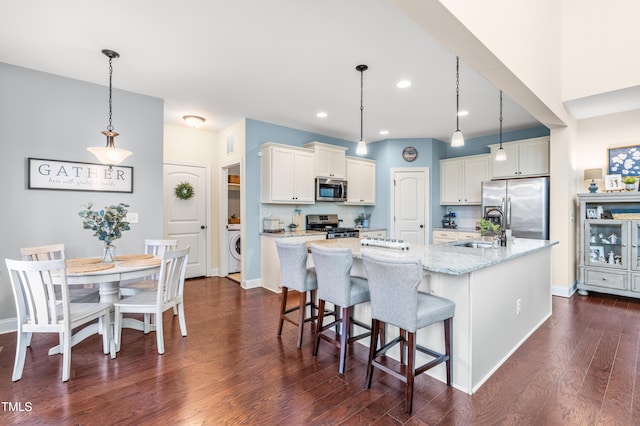 50 Lockamy Ln, Youngsville, NC 27596 - kitchen with a sink, dark wood-type flooring, white cabinets, a large island, and appliances with stainless steel finishes