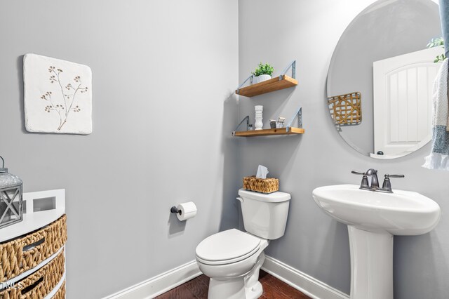 50 Lockamy Ln, Youngsville, NC 27596 - bathroom with a sink, baseboards, toilet, and wood finished floors