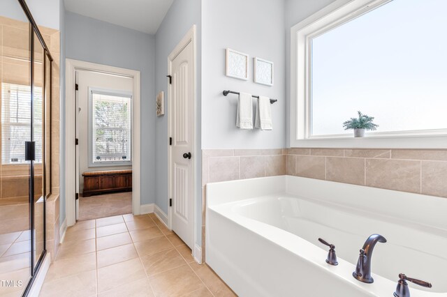 50 Lockamy Ln, Youngsville, NC 27596 - full bathroom featuring tile patterned floors, a stall shower, and a garden tub