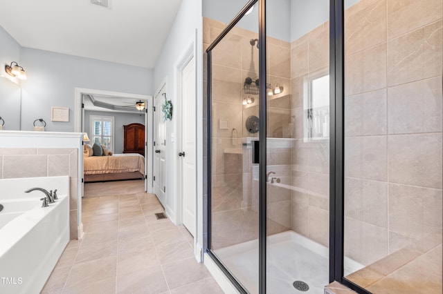 50 Lockamy Ln, Youngsville, NC 27596 - ensuite bathroom featuring tile patterned floors, a garden tub, a ceiling fan, ensuite bath, and a shower stall